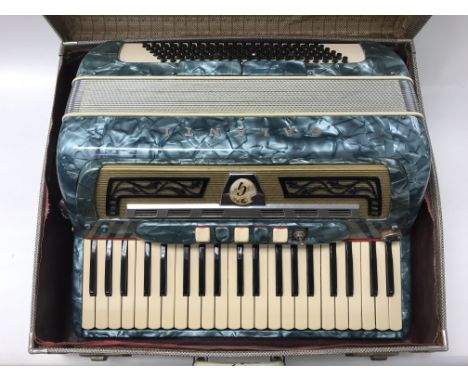 A cased Glanti accordion.