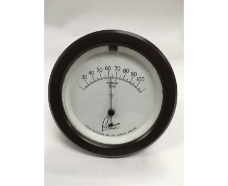 A Rototherm bakelite desk thermometer of circular form.