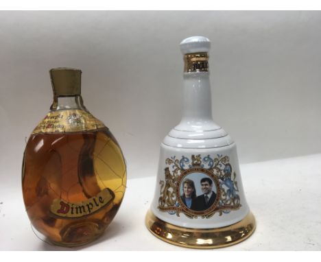 Two decanters of Whisky, one example being a Dimple decanter and the other is a boxed Bells example.
