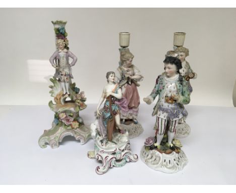 A collection of late 19th Century porcelain candle stick and candelabra base figures. (a lot)