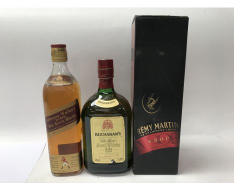 A bottle of 'Johnnie Walker' old Scotch whiskey, a 'Buchanan's' Scotch whiskey and a 'Remy Martin' fine champagne cognac.