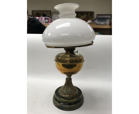 An oil lamp on ceramic base.
