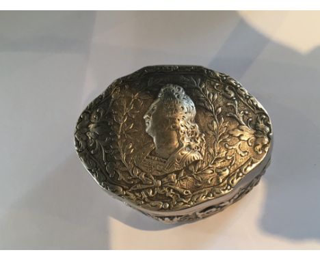 A Continental Silver snuff box decorated with a portrait amoungest foliage. parcel gilt interior. Weight 79g size 7cm markes 