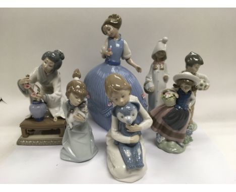 A collection of seven Lladro and Nao figures.