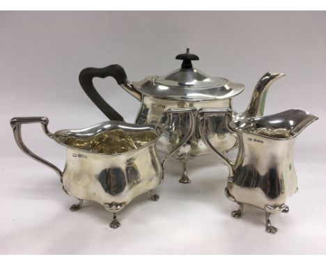 A three piece silver tea service raised on lion paw feet, Sheffield 1902.