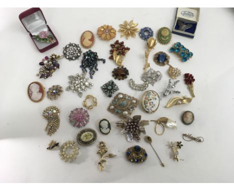 A collection of vintage brooches including a sterling silver butterfly