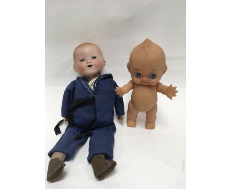 A Kewpie doll and a bisque head soft body sailor doll,stamped A.M Germany