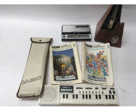 A vintage Stylophone, a Casio electronic instrument and a Metronome.