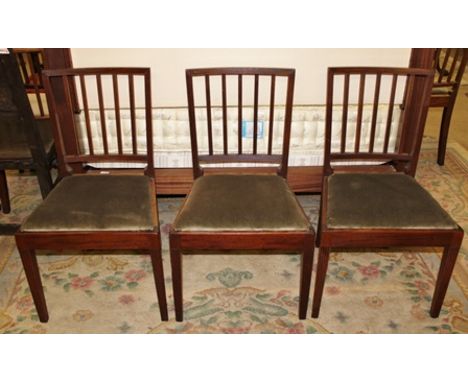 A SET OF SIX GEORGIAN REEDED STICK BACK DINING CHAIRS, each with upholstered drop-in seat pad, on plain square tapering reede
