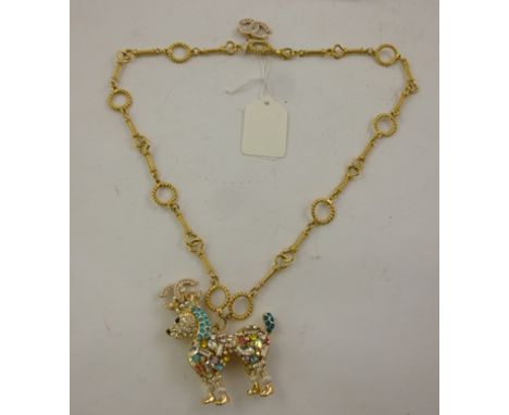 A CHANEL DIAMANTE AND COLOURED GLASS SET PENDANT fashioned as a poodle, on fancy chain 