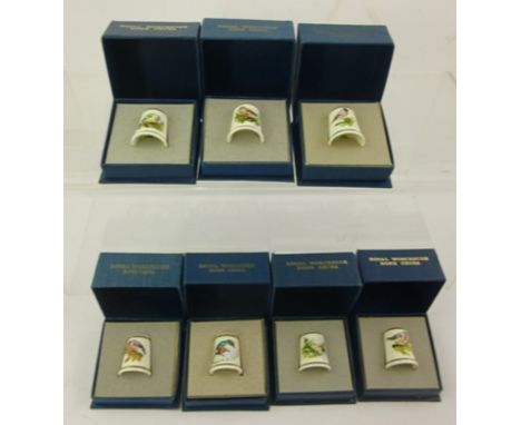 A COLLECTION OF SEVEN ROYAL WORCESTER HAND PAINTED PORCELAIN THIMBLES, wild birds, boxed 