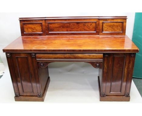 A 19TH CENTURY MAHOGANY TWIN PEDESTAL SIDEBOARD having low panelled back, fitted central cushion drawer with rosette swirl ca