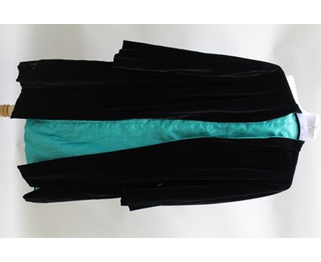 A BLACK VELVET EVENING COAT with jade green lining, together with a 1960's lace EVENING DRESS, a 1970's retro NEGLIGEE, a sil