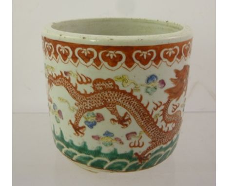 A CHINESE CERAMIC CYLINDER POT painted in the famille verte palette, with two dragons disputing a flaming pearl, raised on th