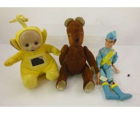 A JOINTED PLUSH TEDDY BEAR 33cm high, together with a THUNDERBIRDS STRING PUPPET and a TOMY LA-LA TELETUBBIE, yellow 