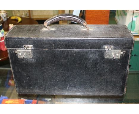 A COLLECTION OF SURGICAL TOOLS in leather case