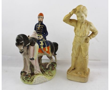 A VICTORIAN STAFFORDSHIRE EARTHENWARE MODEL "Omer Pacha - Success to Turkey", 30cm high, a bisque cream bodied MODEL of a boy