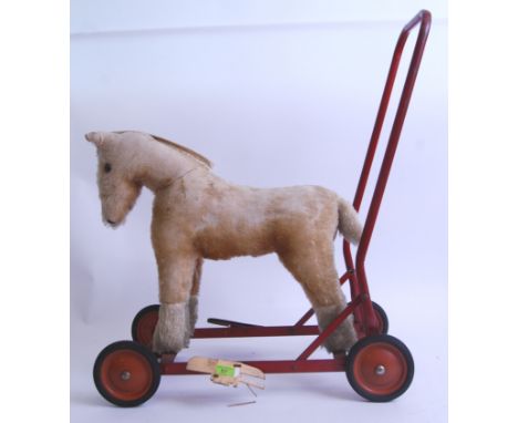 CHILTERN HORSE: A vintage Chiltern made push along ride on stuffed toy horse. Mounted on a metal frame in red, with rubber ty