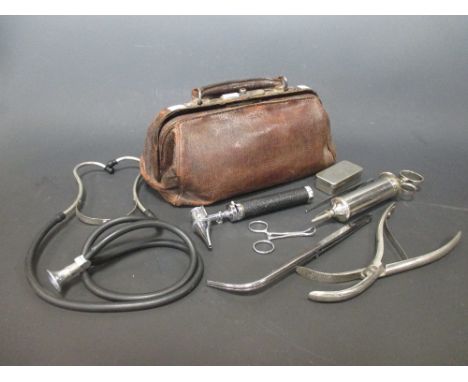 A leather Gladstone-type doctor's bag containing: boxed thermometer boxed, reflex hammer, electric otoscoper with spare head,