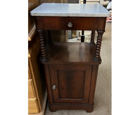 A Victorian mahogany bedside cabinet, with a rectangular marble top and bobbin turned upright, with a drawer and cupboard doo