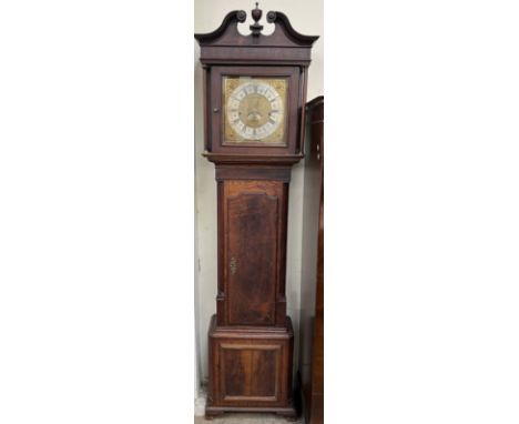 A 19th century oak and mahogany longcase clock, the hood with a broken swan neck pediment and ionic columns above a long trun