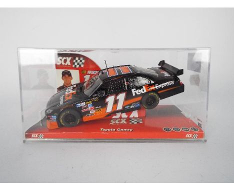 SCX - Slot Car model in 1:32 Scale - # 64110 Toyota Camry Fed Ex Express. Featuring Nascar #11 and Driver Denny Hamlin. Appea
