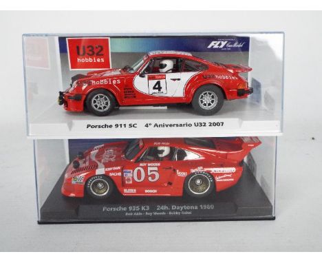 Fly - Two boxed 1:32 scale slot cars from Fly. Lot consists of #99091 Special Edition Porsche 911 SC 'U32 Hobbies' numbered 1