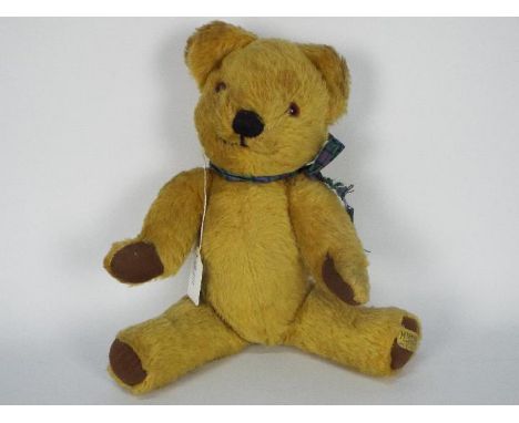 Merrythought - A vintage Merrythought Teddy Bear. The golden mohair bear with plastic eyes, black vertically stitched nose wi