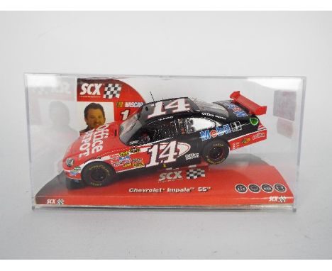 SCX - Slot Car model in 1:32 Scale - # A10061X300 Chevrolet Impala SS. Featuring Nascar #14 and Driver Tony Stewart. Appears 