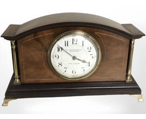 An inlaid mahogany eight day mantle clock retailed by William Drummond and Co Melbourne, width 27 cm