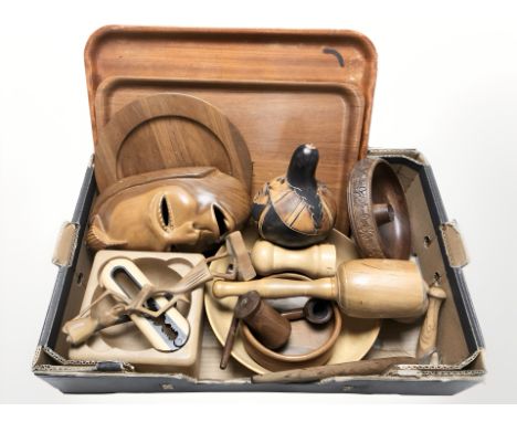 Assorted treen items including serving trays, mask, carved figure, pipe, Danish nut bowl incorporating a pair of nutcrackers,