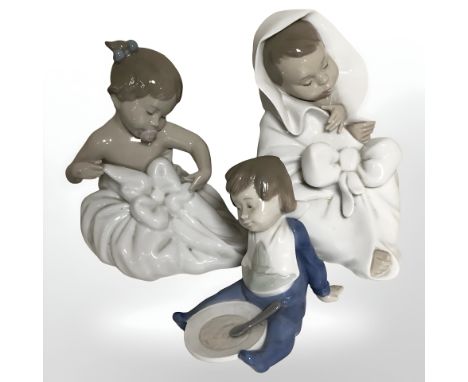 Three Nao figures of babies.