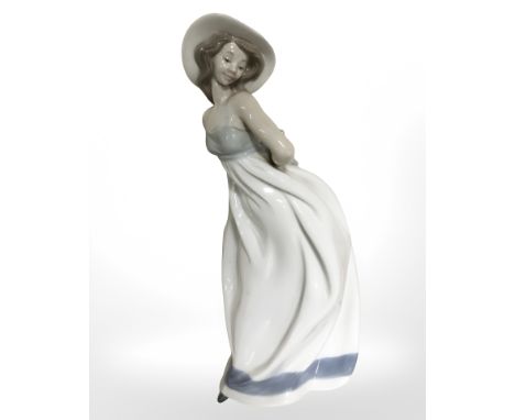 A Nao figure of a lady in a summer dress, height 33 cm.