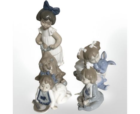 Four Nao figures of young girls.
