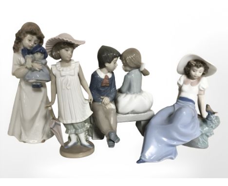 Four Nao figures of boys and girls.
