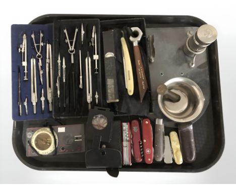 A group of precision drawing instruments, Swiss army knives, compass, cutthroat razor, etc.