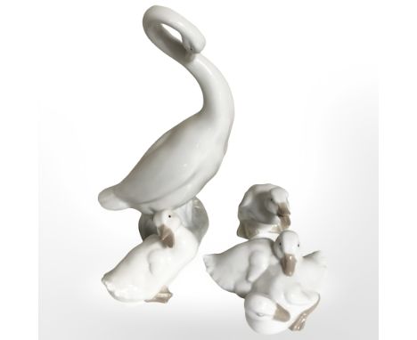 Three Nao figures of geese and a further similar Spanish figure.