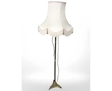 A brass standard lamp with shade, height 182 cm.