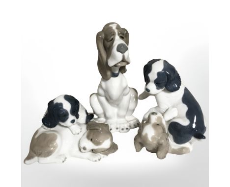 Three Nao figures of dogs.