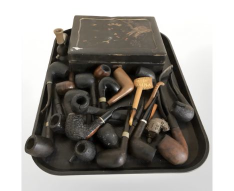 A late 19th century Japanese lacquer export playing card box and a collection of pipes.