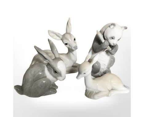 A Nao panda, rabbit and two recumbent deer.