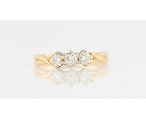 An 18ct yellow gold three stone diamond ring, set with three graduated round brilliant cut diamonds, total diamond weight app