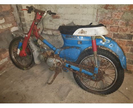 A Vintage Honda C.70 blue/red Motor cycle.