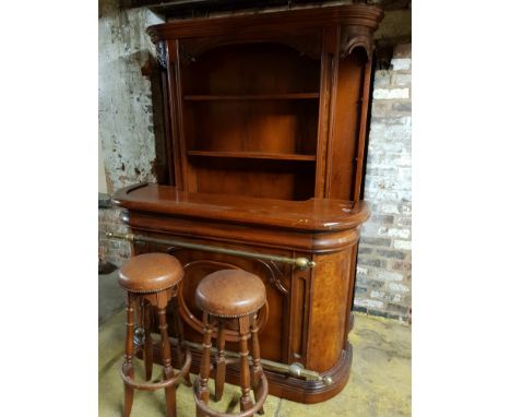 A mahogany bar with built in fridge, large shelf back and two bar stools.