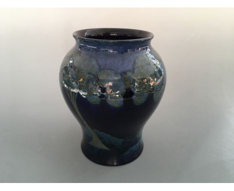 A Moorcroft Moonlit Blue bulbous vase, light blue on dark blue background, with signature to base. Rim diameter 15cm, height 