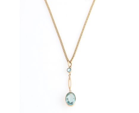A blue paste drop pendant, set with an oval cut blue paste suspended from open metalwork and round cut blue paste, stamped 15