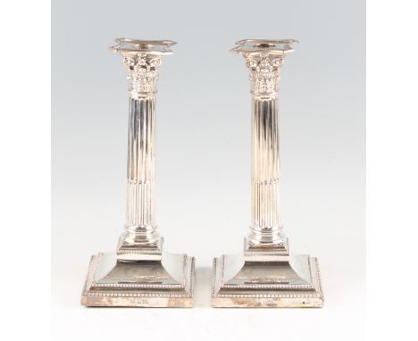 A pair of silver weighted column candlesticks, hallmarked London 1905, makers mark T.B, height approx. 26cm.