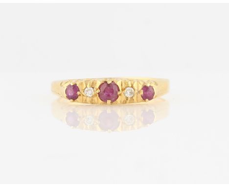 A hallmarked 18ct yellow gold ruby and diamond five stone ring, set with three round cut rubies and two eight-cut diamonds, r