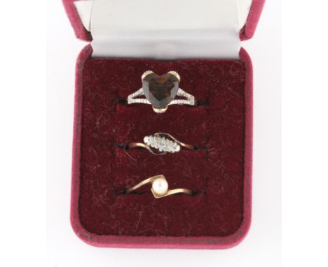 A hallmarked 9ct yellow gold smoky quartz and diamond ring, a three stone diamond ring and a hallmarked 9ct yellow gold pearl