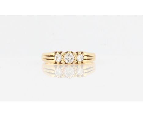 A hallmarked 18ct yellow gold three stone diamond ring, set with three graduated round brilliant cut diamonds, total diamond 